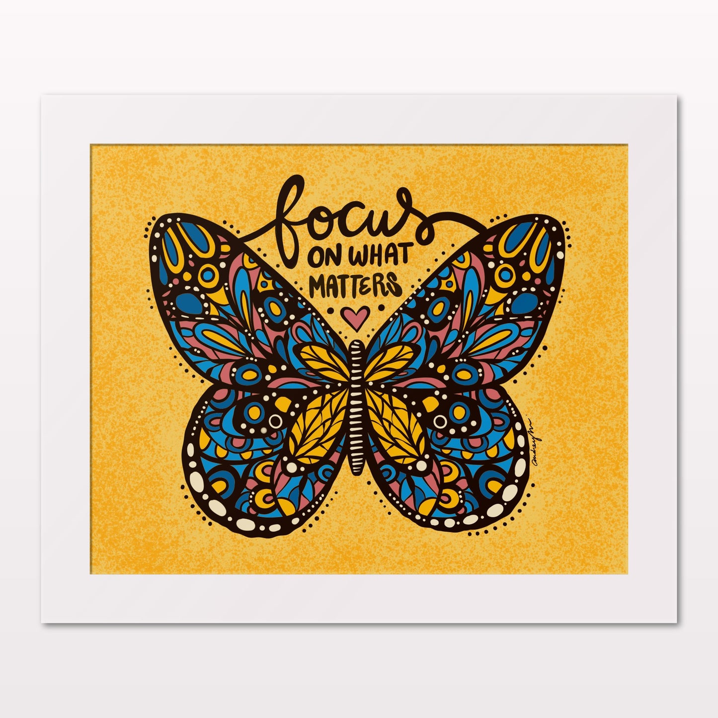 Art print in white frame on white wall