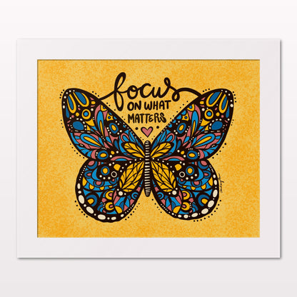 Art print in white frame on white wall